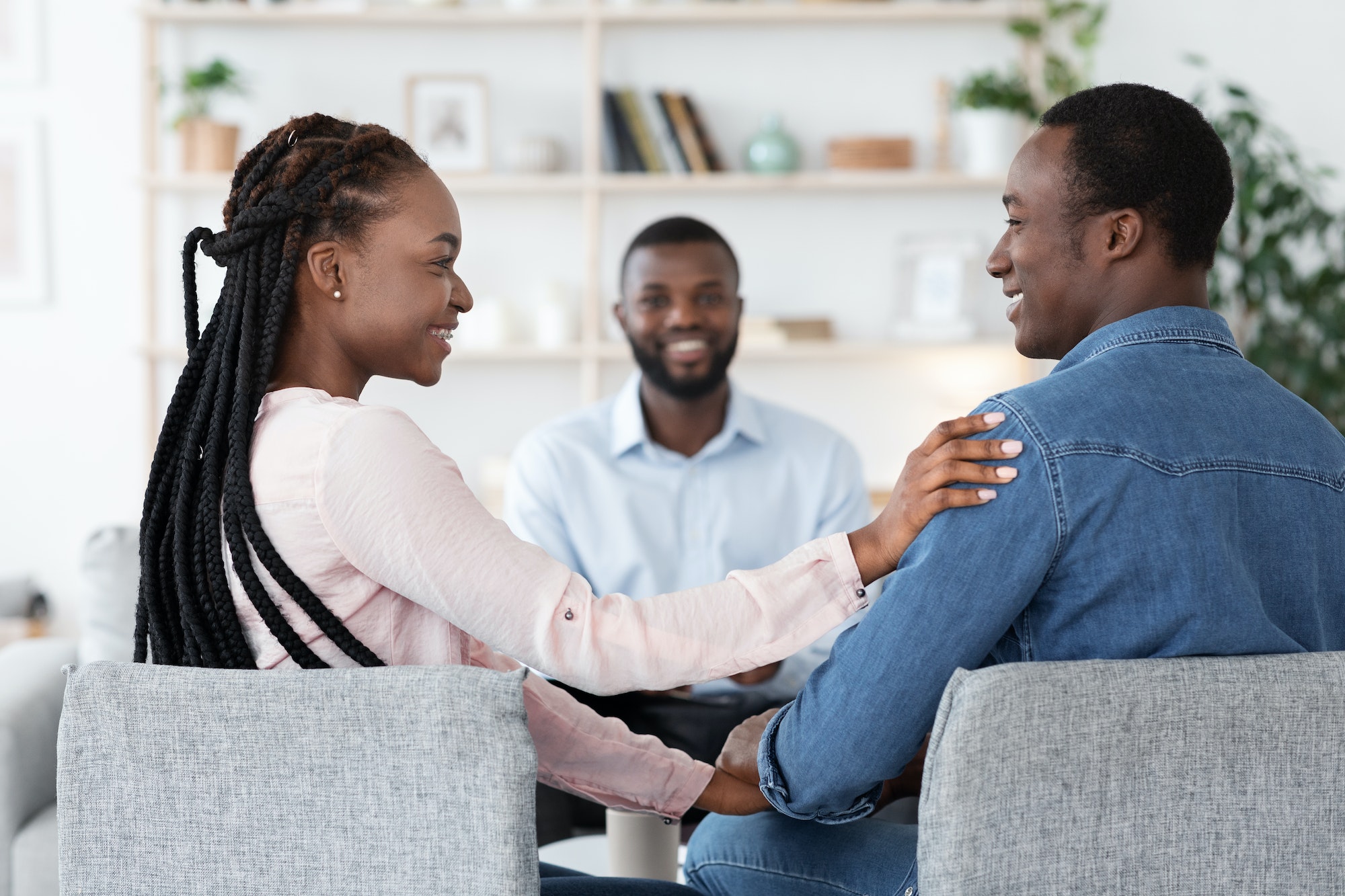 Happy Loving Black Spouses Bonding At Marriage Counselor's Office After Successful Therapy